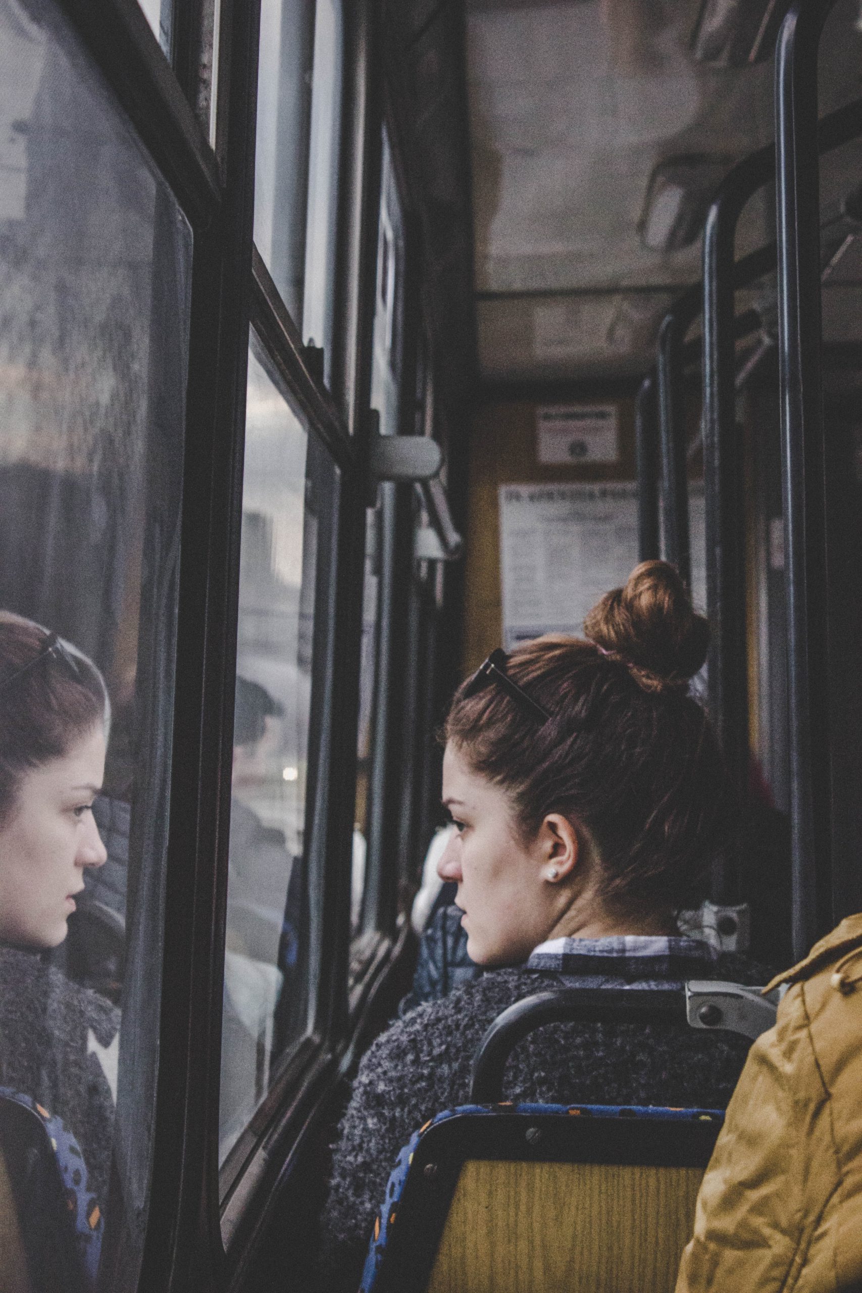 Young woman commuting to work on bus